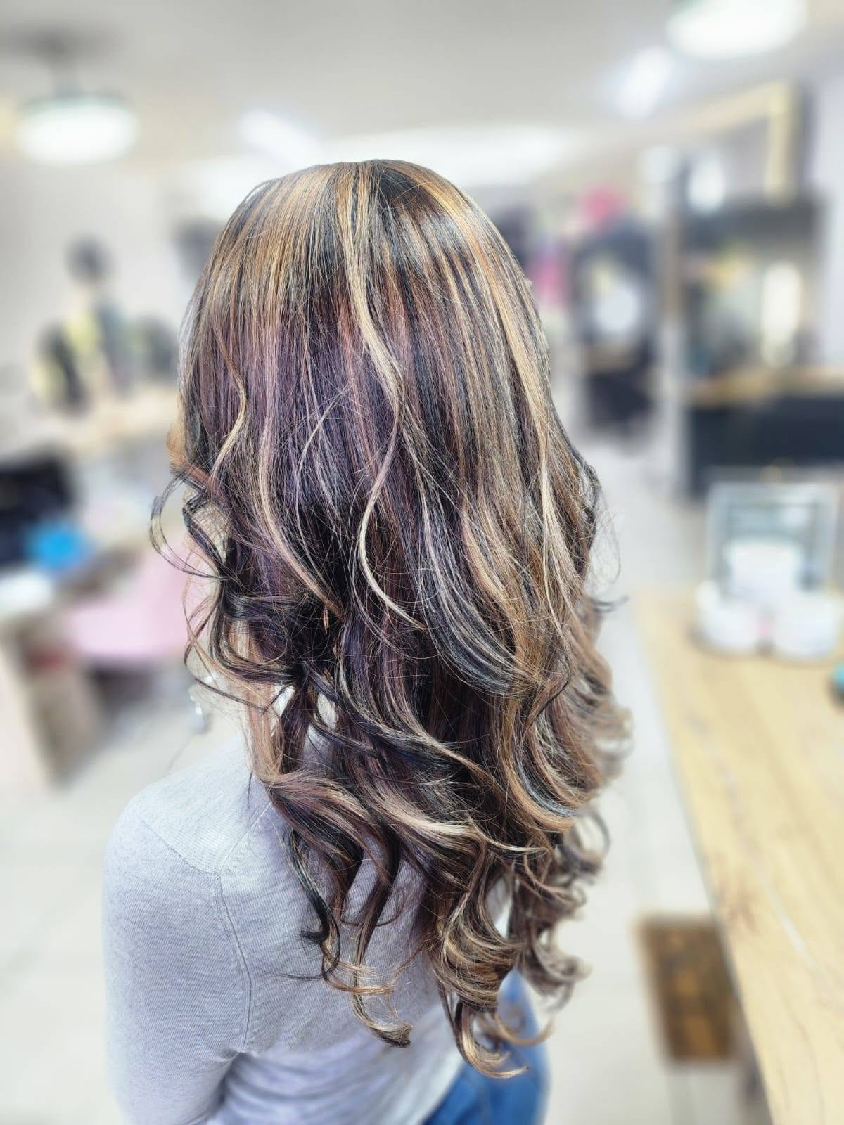 Brunette with caramel highlights and soft curls, back view — Belle Vee, George